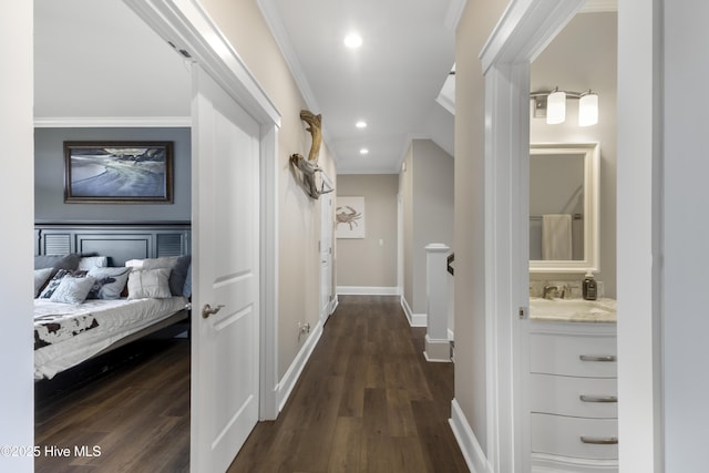 611 New River Inlet Rd, North Topsail Beach, NC 28460 - hall with ornamental molding, dark wood finished floors, recessed lighting, and an upstairs landing