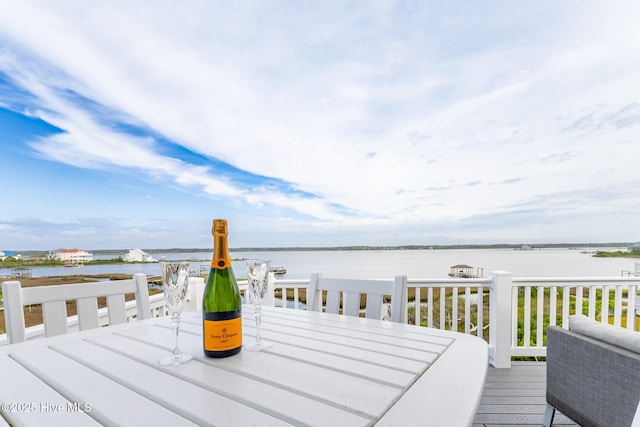 611 New River Inlet Rd, North Topsail Beach, NC 28460 - wooden terrace with outdoor dining area and a water view