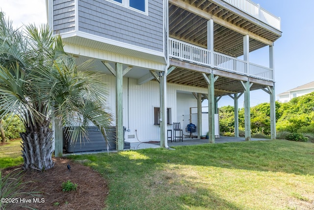 611 New River Inlet Rd, North Topsail Beach, NC 28460 - rear view of house with a lawn and a patio area