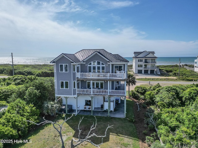 611 New River Inlet Rd, North Topsail Beach, NC 28460 - back of property featuring a balcony, a patio area, a metal roof, a standing seam roof, and a water view