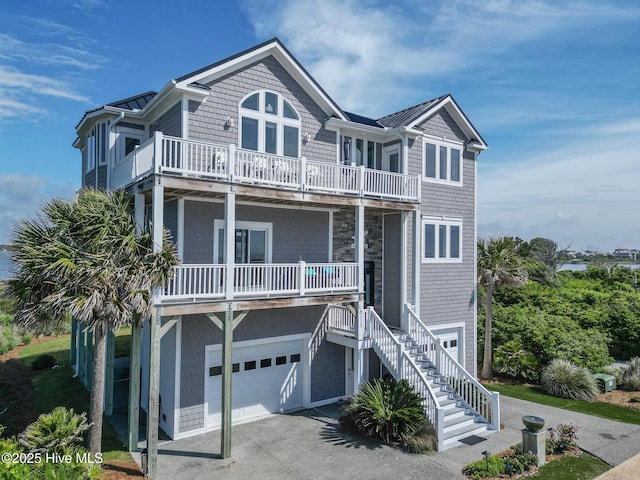 611 New River Inlet Rd, North Topsail Beach, NC 28460 - beach home with a garage, a balcony, stairway, and driveway