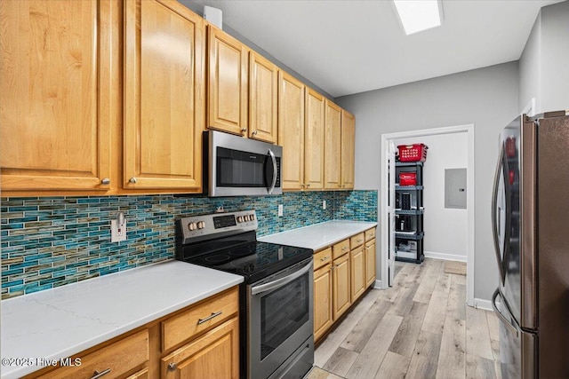 280 Woodlands Way Unit 5, Calabash, NC 28467 - kitchen featuring appliances with stainless steel finishes, decorative backsplash, light countertops, and light wood finished floors