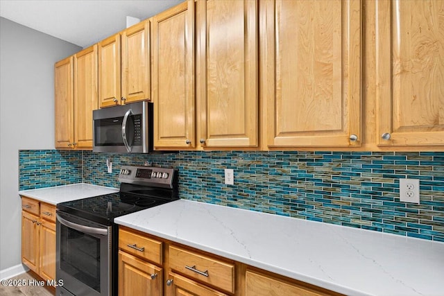 280 Woodlands Way Unit 5, Calabash, NC 28467 - kitchen featuring stainless steel appliances, decorative backsplash, and light stone counters
