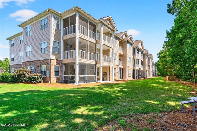 280 Woodlands Way Unit 5, Calabash, NC 28467 - rear view of property with brick siding and a yard