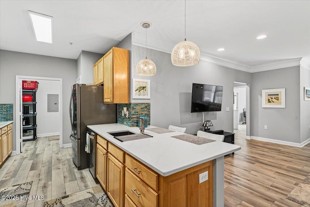 280 Woodlands Way Unit 5, Calabash, NC 28467 - kitchen with decorative backsplash, crown molding, light wood finished floors, light countertops, and stainless steel appliances