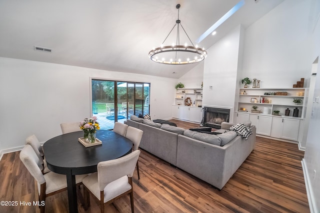 6017 Covenant Ln, Wilmington, NC 28403 - living area with a chandelier, high vaulted ceiling, dark wood-type flooring, and a fireplace