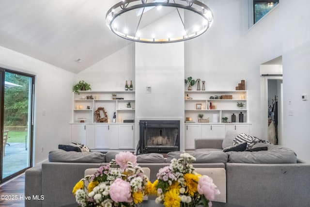 6017 Covenant Ln, Wilmington, NC 28403 - living room with high vaulted ceiling, a fireplace, and wood finished floors
