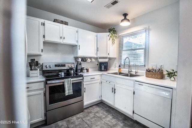6017 Covenant Ln, Wilmington, NC 28403 - kitchen with white appliances, white cabinets, tile patterned floors, and light countertops