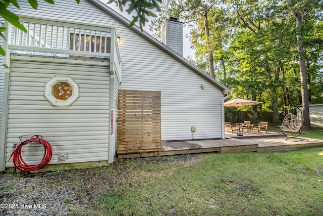 6017 Covenant Ln, Wilmington, NC 28403 - view of side of home with a wooden deck, a chimney, and a yard