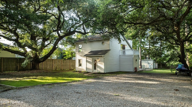 6017 Covenant Ln, Wilmington, NC 28403 - view of side of home with driveway, a shed, a chimney, and a balcony