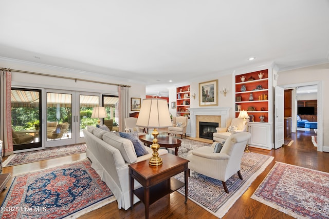 2000 Marsh Harbor Pl, Wilmington, NC 28405 - living room with a fireplace with flush hearth, crown molding, wood finished floors, built in shelves, and recessed lighting