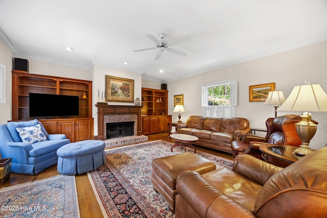 2000 Marsh Harbor Pl, Wilmington, NC 28405 - living room featuring wood finished floors, a ceiling fan, ornamental molding, a fireplace, and recessed lighting