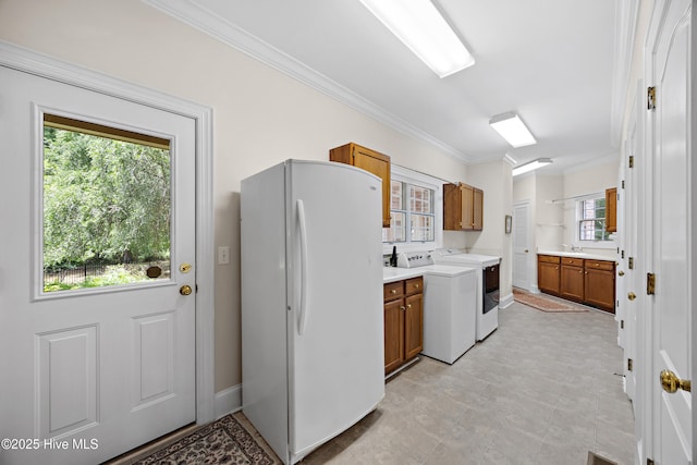2000 Marsh Harbor Pl, Wilmington, NC 28405 - laundry area featuring cabinet space, ornamental molding, and independent washer and dryer