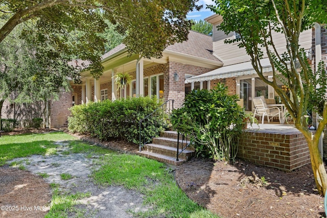 2000 Marsh Harbor Pl, Wilmington, NC 28405 - view of front of property featuring brick siding, a shingled roof, and a patio