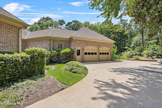 2000 Marsh Harbor Pl, Wilmington, NC 28405 - view of home's exterior with brick siding, an attached garage, and driveway
