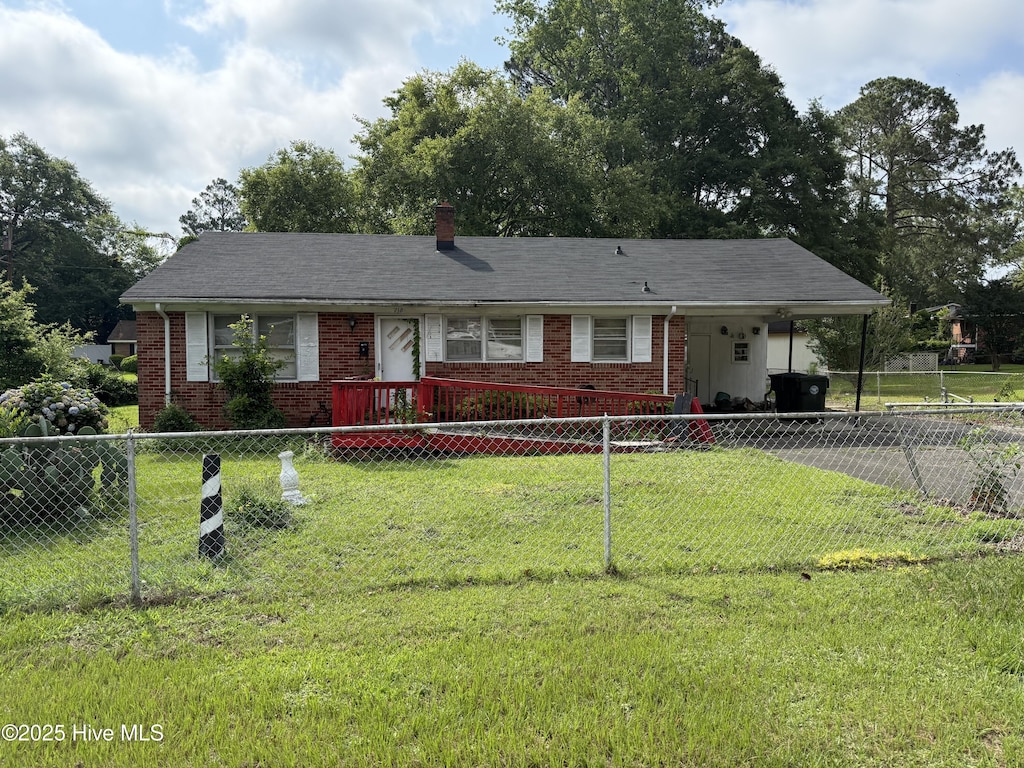 718 Franklin St, Goldsboro, NC 27530 - view of front of house with brick siding, an attached carport, driveway, and a chimney