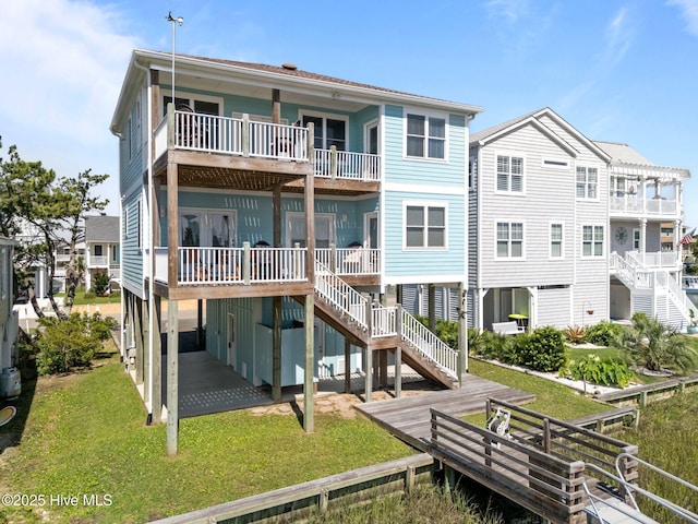 130 Raleigh St, Holden Beach, NC 28462 - back of house with a balcony and a yard