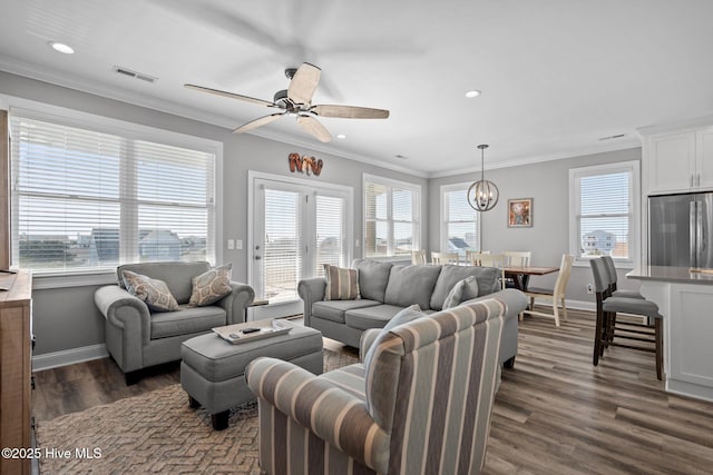 130 Raleigh St, Holden Beach, NC 28462 - living area with ceiling fan, dark wood-type flooring, ornamental molding, recessed lighting, and a chandelier