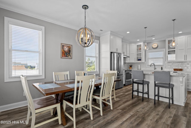 130 Raleigh St, Holden Beach, NC 28462 - dining area with plenty of natural light, a chandelier, dark wood-type flooring, ornamental molding, and recessed lighting