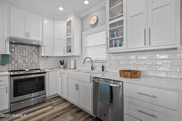 130 Raleigh St, Holden Beach, NC 28462 - kitchen featuring stainless steel appliances, under cabinet range hood, light countertops, white cabinets, and glass insert cabinets