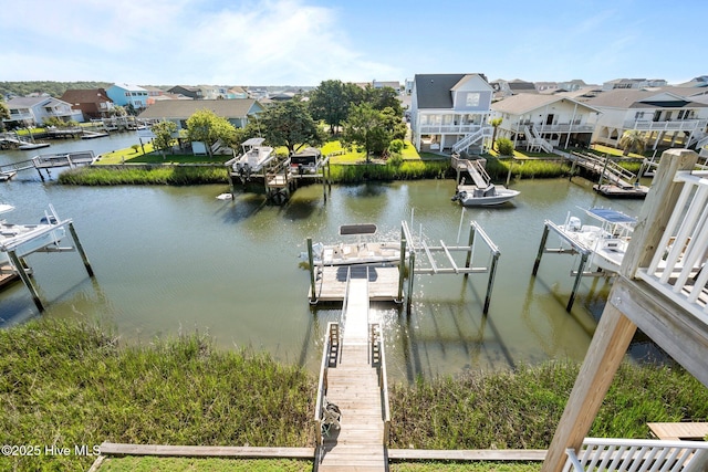 130 Raleigh St, Holden Beach, NC 28462 - dock featuring boat lift, a water view, and a residential view