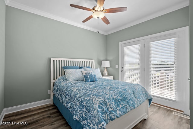 130 Raleigh St, Holden Beach, NC 28462 - bedroom with access to exterior, multiple windows, crown molding, wood finished floors, and ceiling fan