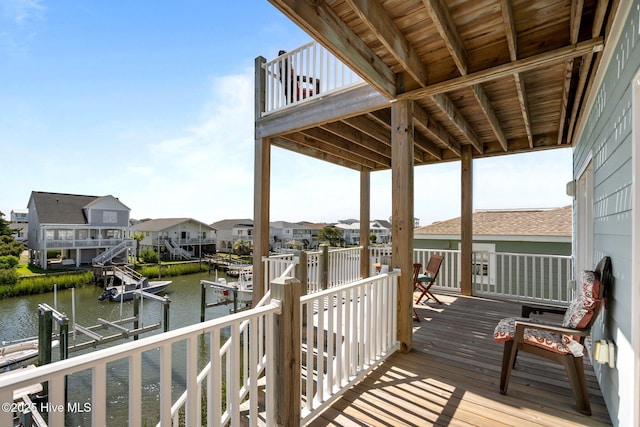 130 Raleigh St, Holden Beach, NC 28462 - deck with boat lift, a water view, a dock, and a residential view