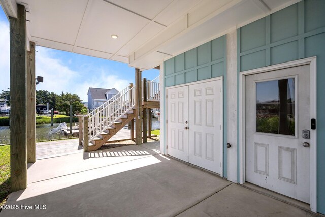 130 Raleigh St, Holden Beach, NC 28462 - doorway to property featuring a patio area, board and batten siding, and a water view