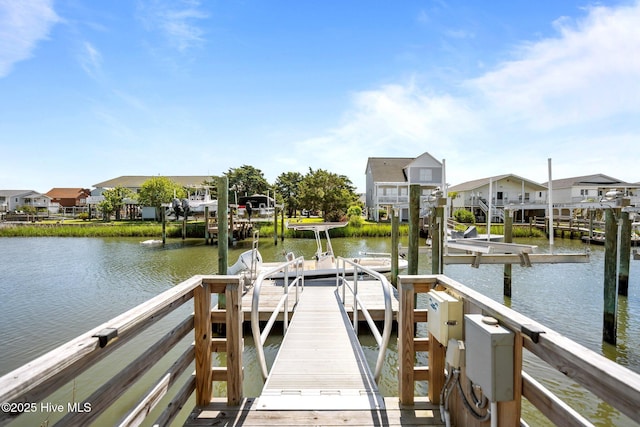 130 Raleigh St, Holden Beach, NC 28462 - dock area with boat lift, a water view, and a residential view