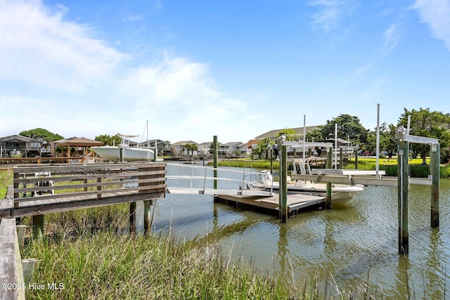 130 Raleigh St, Holden Beach, NC 28462 - dock featuring boat lift, a water view, and a residential view