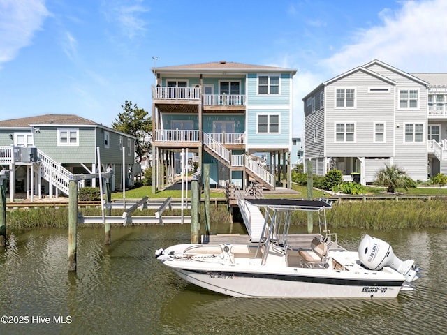 130 Raleigh St, Holden Beach, NC 28462 - dock area with a water view, a balcony, and stairway