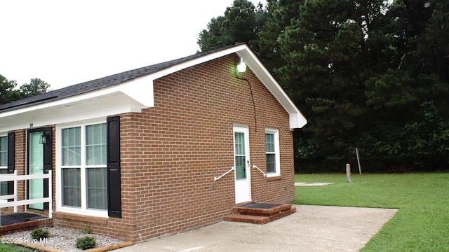 121 Walter Dr, Battleboro, NC 27809 - view of side of home featuring brick siding, a yard, and a patio