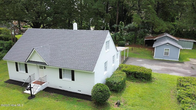 309 Mcgwigan St, Enfield, NC 27823 - view of front of house with a chimney, crawl space, a front yard, brick siding, and a shingled roof