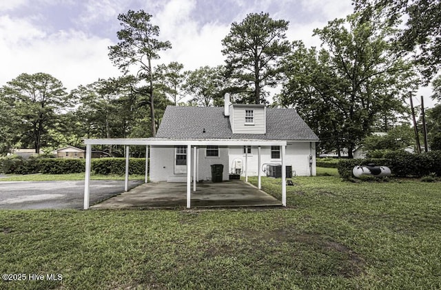 309 Mcgwigan St, Enfield, NC 27823 - rear view of house with a yard and asphalt driveway