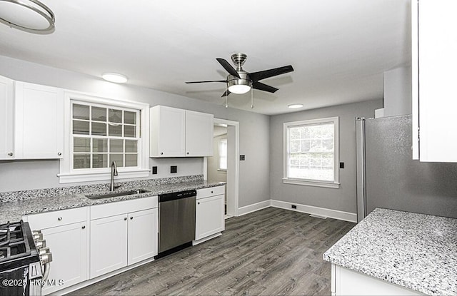 309 Mcgwigan St, Enfield, NC 27823 - kitchen featuring stainless steel appliances, ceiling fan, light stone countertops, and white cabinetry