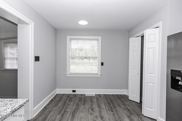 309 Mcgwigan St, Enfield, NC 27823 - unfurnished dining area featuring dark wood finished floors and baseboards