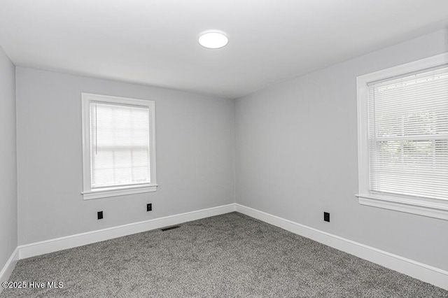 309 Mcgwigan St, Enfield, NC 27823 - empty room featuring carpet and healthy amount of natural light