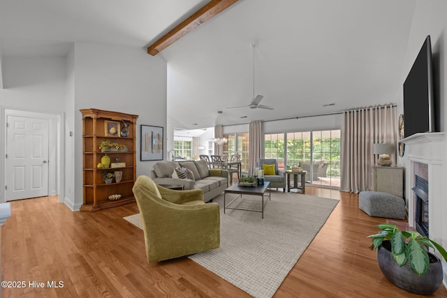 118 Tremayne Dr, New Bern, NC 28560 - living area featuring high vaulted ceiling, ceiling fan, a glass covered fireplace, beam ceiling, and light wood-style flooring