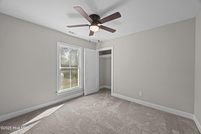 902 College St, Vanceboro, NC 28586 - unfurnished bedroom with light carpet, a closet, and a ceiling fan