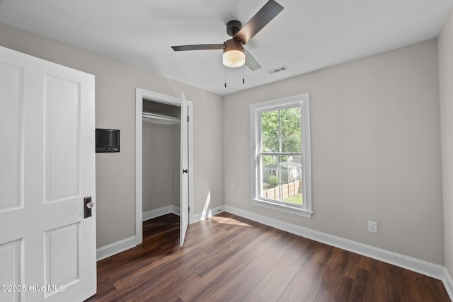 902 College St, Vanceboro, NC 28586 - unfurnished bedroom with dark wood-style flooring, a closet, and ceiling fan