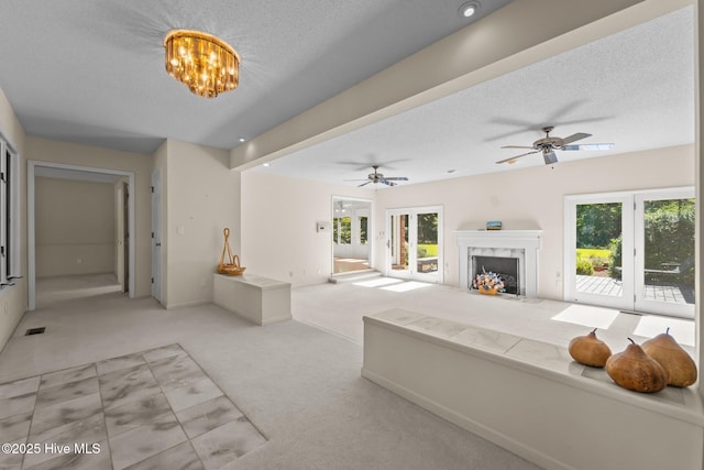 15 Magnolia Ave, Pinehurst, NC 28374 - carpeted living area with a high end fireplace, a textured ceiling, a ceiling fan, and a chandelier
