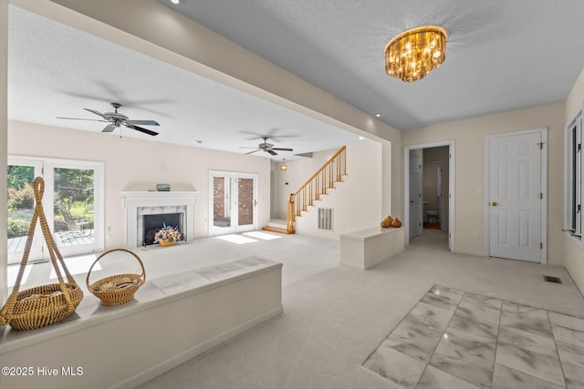 15 Magnolia Ave, Pinehurst, NC 28374 - living room featuring stairs, a high end fireplace, carpet floors, a textured ceiling, and ceiling fan