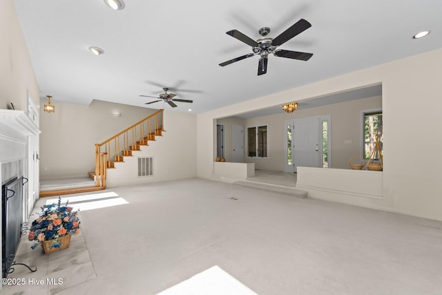 15 Magnolia Ave, Pinehurst, NC 28374 - unfurnished living room with stairway, carpet flooring, ceiling fan, recessed lighting, and a high end fireplace