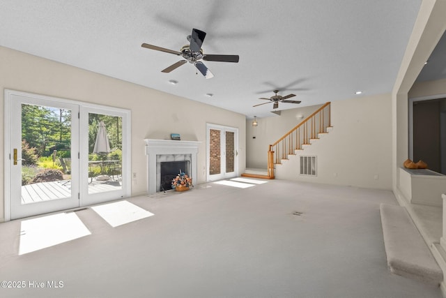 15 Magnolia Ave, Pinehurst, NC 28374 - unfurnished living room featuring carpet, ceiling fan, stairs, and a premium fireplace