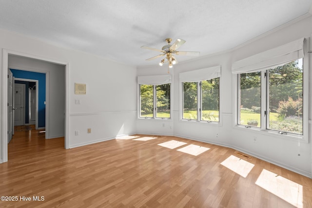 15 Magnolia Ave, Pinehurst, NC 28374 - spare room with ceiling fan, light wood-style flooring, a textured ceiling, and crown molding