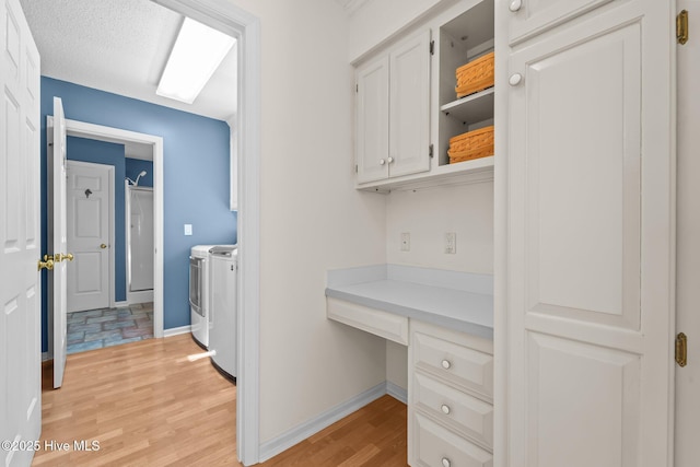 15 Magnolia Ave, Pinehurst, NC 28374 - laundry area with washer and dryer, light wood-style floors, cabinet space, and a desk