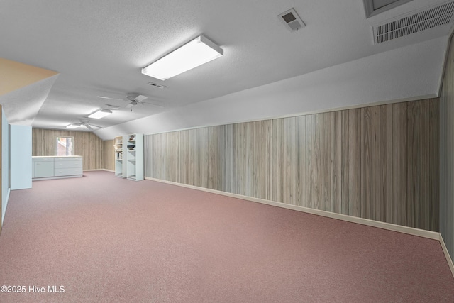 15 Magnolia Ave, Pinehurst, NC 28374 - additional living space featuring lofted ceiling, ceiling fan, carpet floors, and a textured ceiling