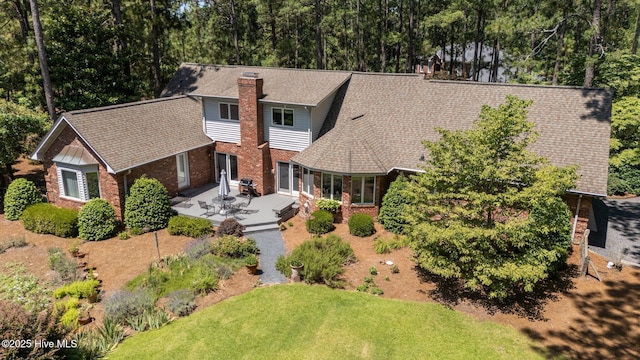 15 Magnolia Ave, Pinehurst, NC 28374 - view of front of property featuring a chimney, brick siding, a front yard, and a patio