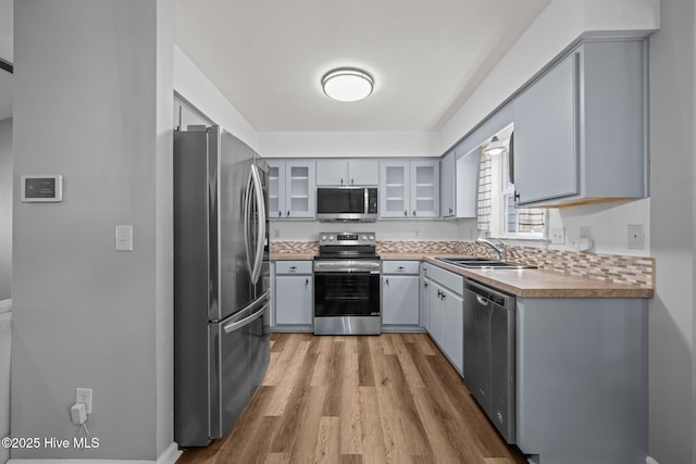 1134 Tebo Rd, New Bern, NC 28562 - kitchen featuring appliances with stainless steel finishes, light wood finished floors, and gray cabinetry
