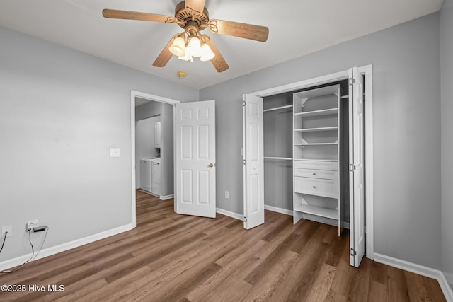 1134 Tebo Rd, New Bern, NC 28562 - unfurnished bedroom with wood finished floors, a ceiling fan, a closet, and separate washer and dryer